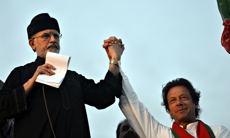 Tahir-ul-Qadri (left) joins hands with Imran Khan during a protest near prime minister's residence