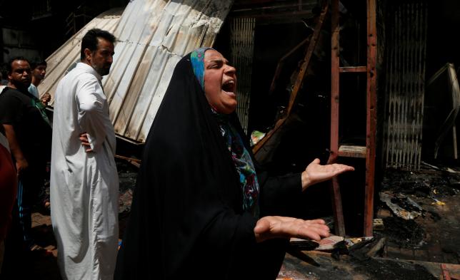 A woman reacts at the scene of a car bomb attack in Baghdad's mainly Shi'ite district of Sadr City