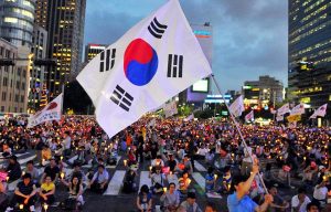 A South Korean man holds a national flag during an anti-US beef rally in Seoul, South Korea. Korean announced it will resume US beef imports from June 26 after negotiating extra safeguards against mad cow disease, despite protests by tens of thousands over recent weeks.